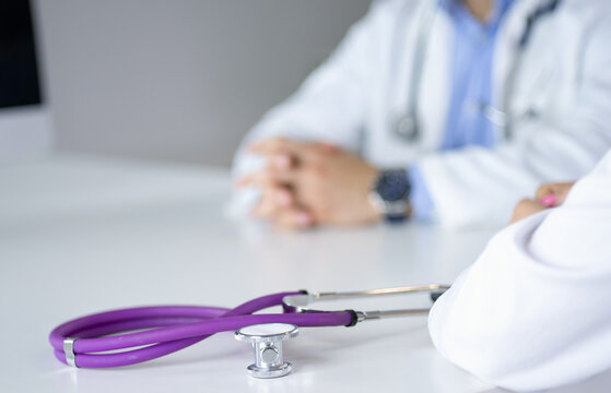 Two Doctors Discussing And Working Together In A Medical Office