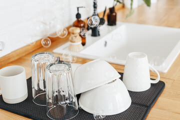 Clean glasses and dishes on towel on the kitchen table after washing