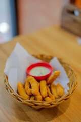 Fried chicken sticks with sauce in basket