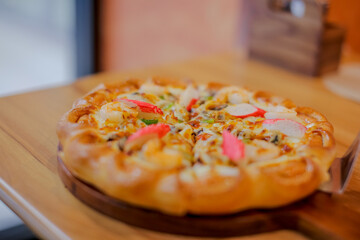 Tropical Seafood Pizza on wooden background, Prawn Crab Squid Shell