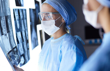 Two female women medical doctors looking at x-rays in a hospital