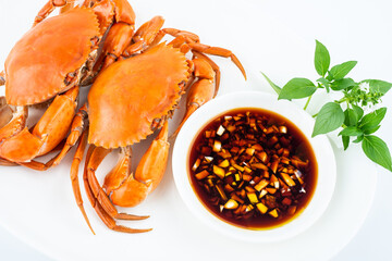 A dish of delicious steamed red sturgeon crab on white background