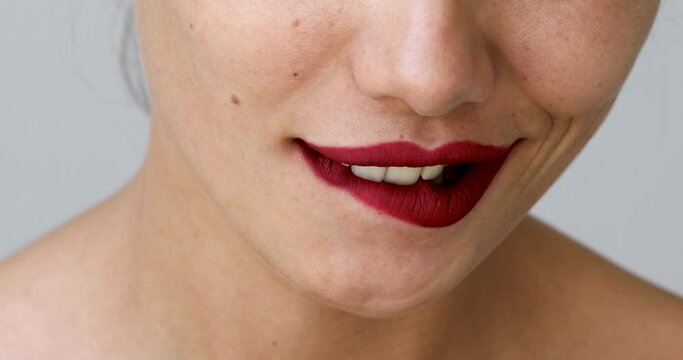Woman biting her red lips