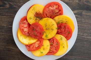 Colorful summer salad with tomatoes and nectarines, close up. Top view.