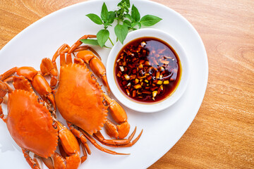 A dish of delicious steamed red sturgeon crab on wooden table