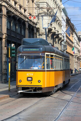 Fototapeta na wymiar Tram giallo a Milano in Italia, Yellow streetcar in Milan city in Italy 