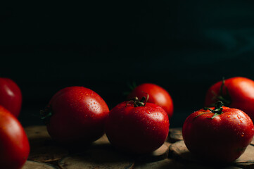 A lot of red tomatoes on a black background. High quality photo