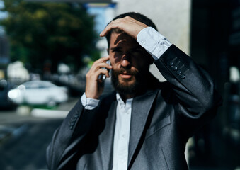 business man in a suit talking on the phone outdoors business manager executive