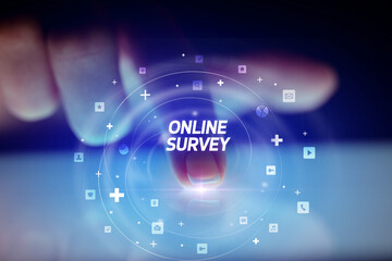 Finger touching tablet with social media icons and ONLINE SURVEY