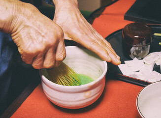 A japanese woman shows the matcha tea ceremony