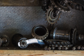 Metal parts for a bicycle on a shelf in the garage. Close-up