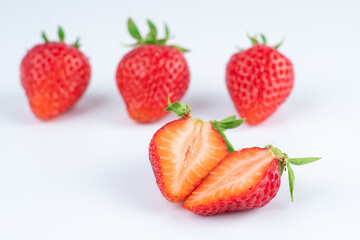 several strawberries are removed from the glare on a white background