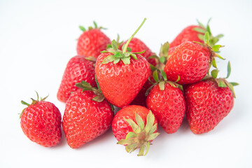 several strawberries are removed from the glare on a white background