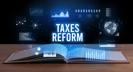 TAXES REFORM inscription coming out from an open book, creative business concept