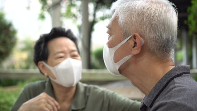 Asian senior elder couple wearing masks and concern about covid pandemic together