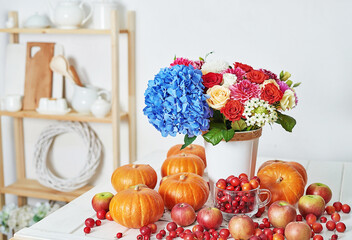 Autumn harvest pumpkin background. Pumpkins, apples and flowers on table. Thanksgiving table. Copy space. Halloween or seasonal autumnal. Design mock up. Greeting card. Fall kitchen.