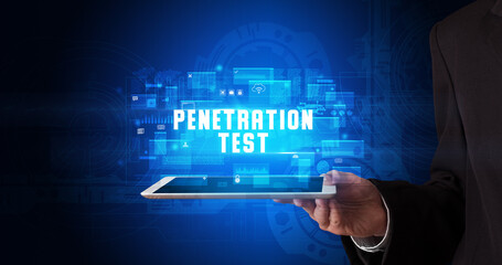 Young business person working on tablet and shows the digital sign: PENETRATION TEST