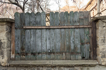 The texture of weathered wooden wall. Aged wooden plank fence of vertical flat boards