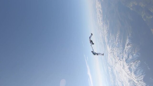 Skydivers over snowy mountains in Norway