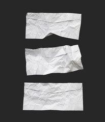 White ripped note, notebook paper stuck with sticky tape on black background.