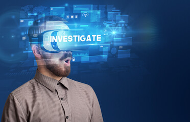 Businessman looking through Virtual Reality glasses with INVESTIGATE inscription, innovative security concept