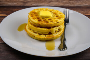 waffles top with syrup and butter