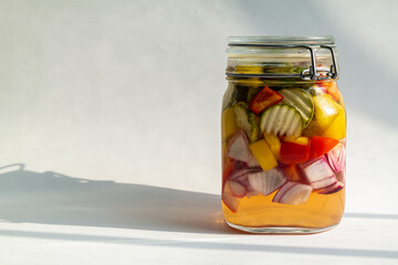 Handmade delicious pickle in glass bottle on a white background