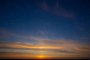 summer evening, sunset in yellow, orange and pink with clouds, background