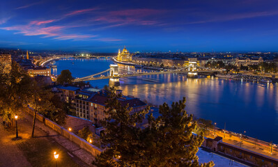Fototapeta na wymiar Beautiful evening image of Budapest, incredible view on Budapest cityscape, with streetlight and colorful sky during sunset. wonderful picturesque Scene. Popular Travel destinations. perfect postcard