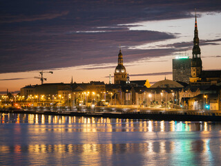 Long exposure night cityscape in Riga, Latvia with reflections over water