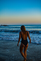 Fototapeta na wymiar woman in a bikini posing on the beach