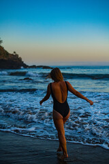 woman in a bikini posing on the beach