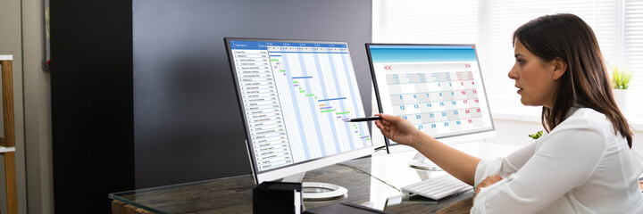 Employee Working On Calendar Schedule