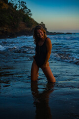 woman in a bikini posing on the beach