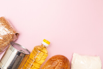 Set of grocery items from buckwheat, sugar, canned food, oil on paper background. Food delivery concept. Donation concept. Top view. Flat lay