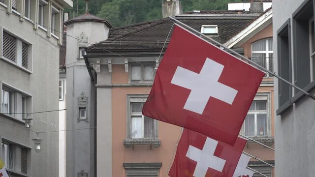Swiss flag on a flagpole attached to a wall