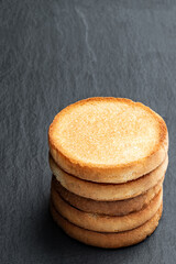 Stack of crispbakes on black stone background