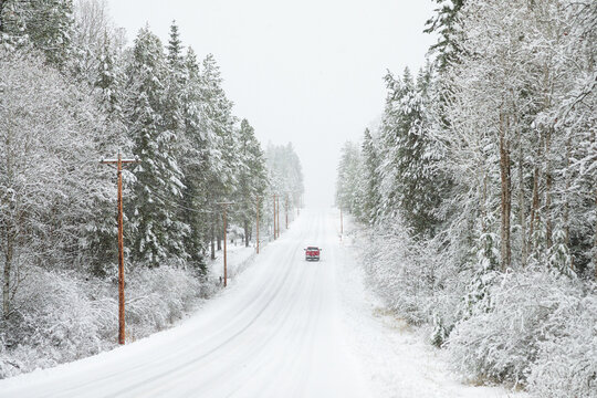 Original Winter Photograph On A Red Pick Up Truck Driving Down A Long Snowy Road In The Forest