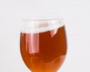 glass of home made craft beer and bag of light malt  on white background. Craft beer brewing from grain barley pale malt.