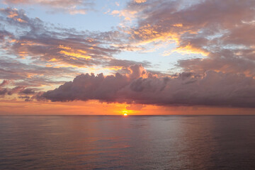 Beautiful cloudscape over the sea, sunrise shot or sunset with orange light stary