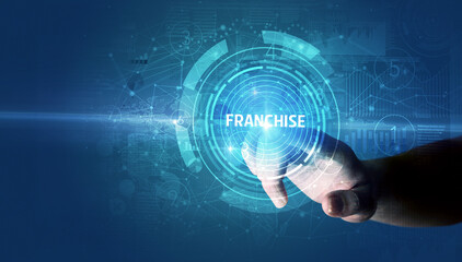 Obraz premium Hand touching FRANCHISE button, modern business technology concept