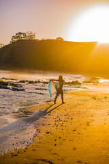 woman dancing on a beach at sunrise