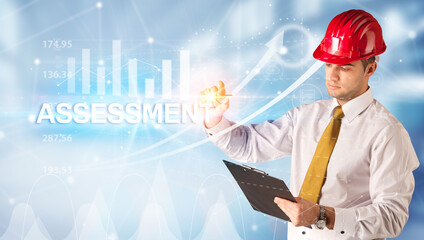Young businessman with helmet drawing ASSESSMENT inscription, modern business technology concept