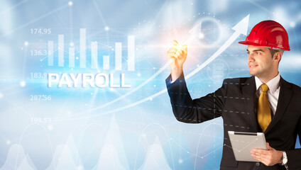 Young businessman with helmet drawing PAYROLL inscription, modern business technology concept