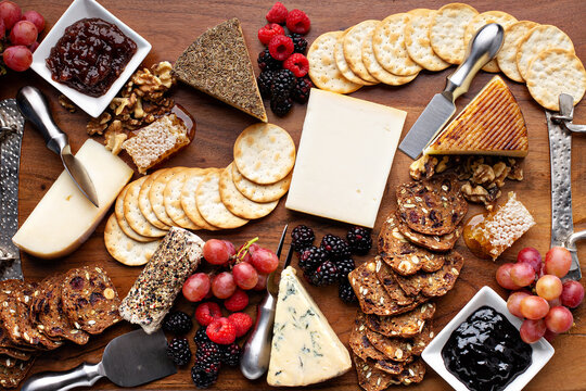 Cheese and snack board with fruit and crackers, cheese variety