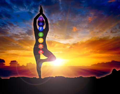 silhouette of a woman in a yoga pose - chakras and meditation