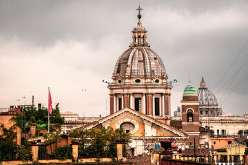 Obraz na płótnie Canvas The spires and domes of many cathedrals rise heavenward across the Rome, Italy skyline.