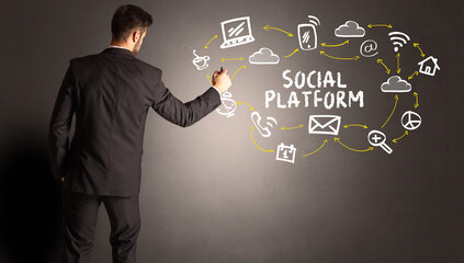 businessman drawing social media icons with SOCIAL PLATFORM inscription, new media concept