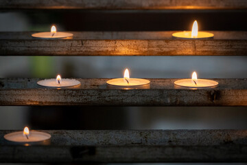 Votive Candles create a sense of peace as they burn in a Catholic Cathedral in Rome, Italy.