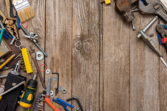 Old repair tools on a wooden background. Top view.